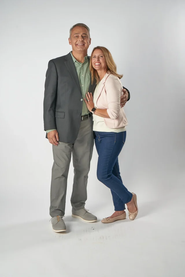 A couple smiling.